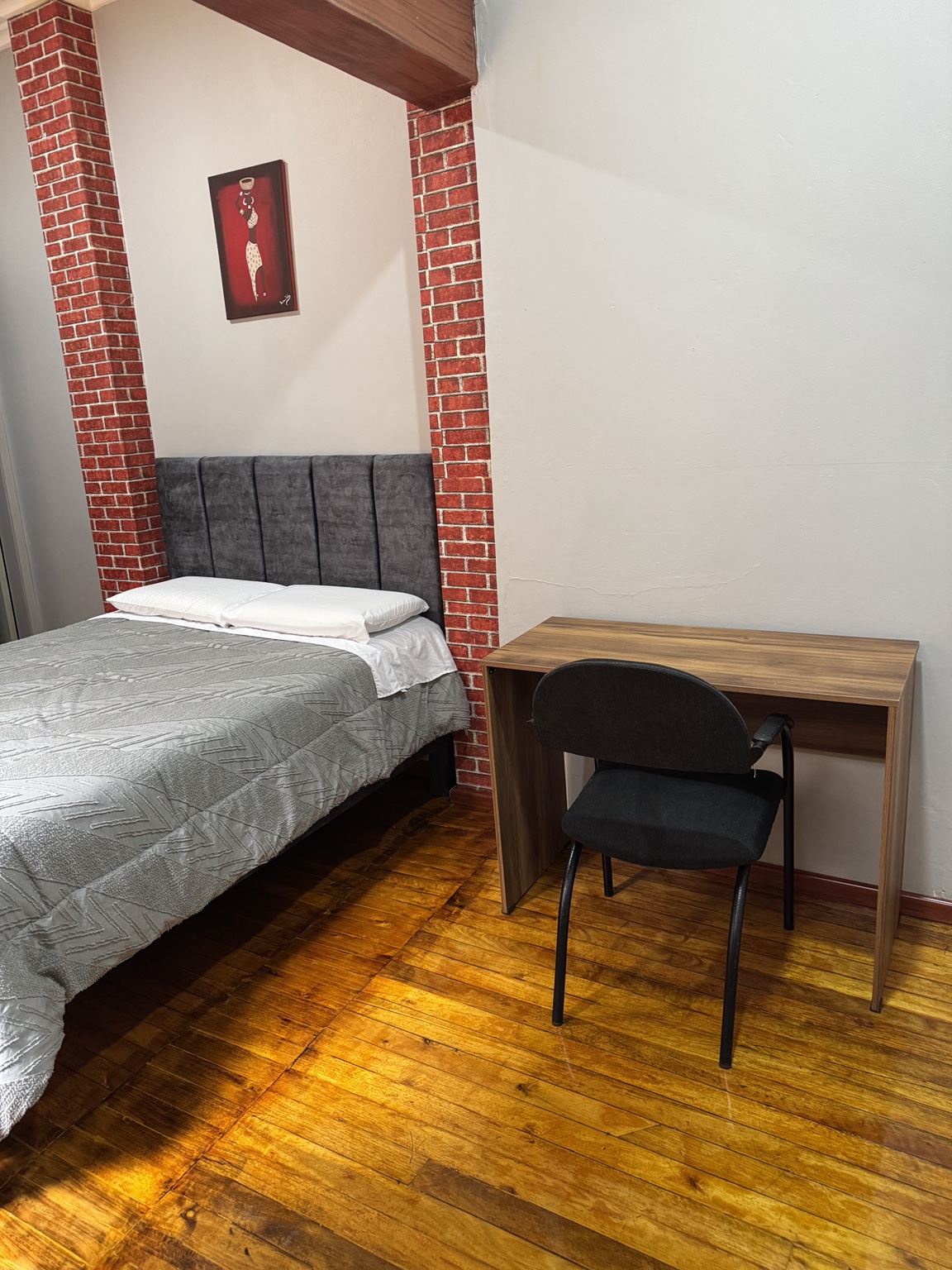 Double bed and desk in Suite 3