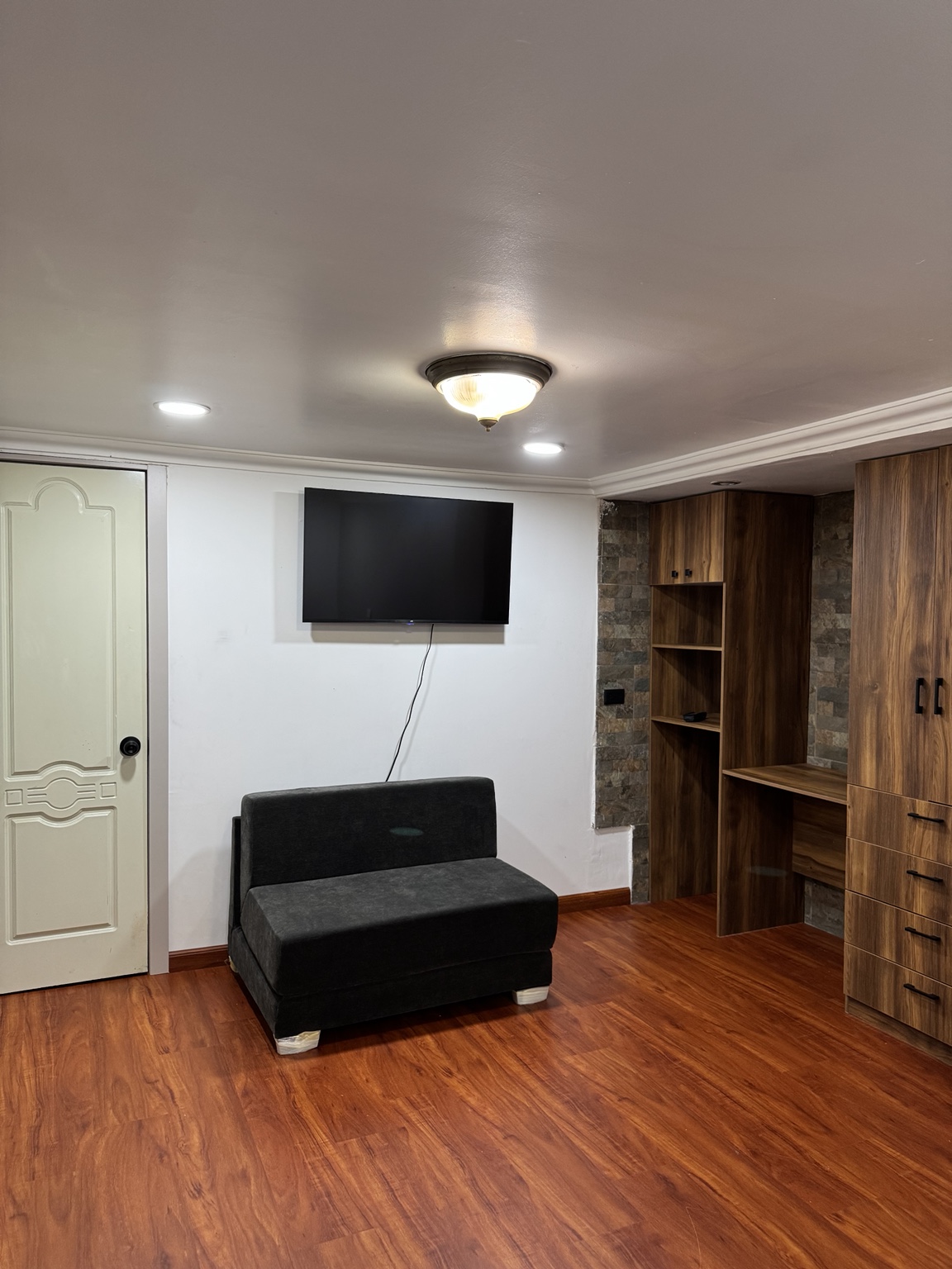 Sofa bed, television, wardrobe and desk